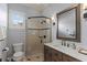 Bathroom showcasing a glass door shower with a dark frame, wood vanity and modern lighting at 3535 Lake Sarah Dr, Orlando, FL 32804