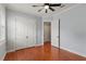 Bright bedroom features hardwood floors, ceiling fan, and white double-door closet with access to another room at 3535 Lake Sarah Dr, Orlando, FL 32804