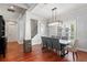 Bright dining room with elegant chandelier, hardwood floors, and large windows at 3535 Lake Sarah Dr, Orlando, FL 32804