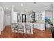 Open kitchen with breakfast bar, stainless steel appliances, and white cabinetry at 3535 Lake Sarah Dr, Orlando, FL 32804