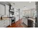 Gourmet kitchen featuring stainless steel appliances, granite countertops, and white cabinetry at 3535 Lake Sarah Dr, Orlando, FL 32804