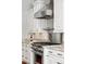 Close-up of a kitchen featuring stainless steel appliances, granite countertops, and white cabinets at 3535 Lake Sarah Dr, Orlando, FL 32804