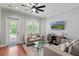 Cozy living room with comfortable seating, a glass coffee table, and natural light from a nearby door at 3535 Lake Sarah Dr, Orlando, FL 32804
