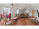 Spacious living area with hardwood floors, multiple ceiling fans, a TV and comfortable seating at 3535 Lake Sarah Dr, Orlando, FL 32804