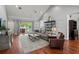 Spacious living room with vaulted ceilings, hardwood floors, and sliding glass doors to the pool area at 3535 Lake Sarah Dr, Orlando, FL 32804