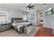Serene main bedroom with a king-size bed, TV, and ample natural light, creating a peaceful retreat at 3535 Lake Sarah Dr, Orlando, FL 32804