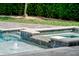 Close-up of a pool with a spa and stone tiling in a backyard at 3535 Lake Sarah Dr, Orlando, FL 32804