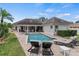 Backyard area featuring a swimming pool, a jacuzzi, lounge chairs, and the home's exterior at 3535 Lake Sarah Dr, Orlando, FL 32804