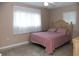 Comfortable bedroom with wood bedframe, two bright windows, and wood dresser at 36019 Clear Lake Dr, Eustis, FL 32736