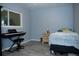 Comfortable bedroom with wood-look tile flooring, bright window, and a piano at 36019 Clear Lake Dr, Eustis, FL 32736