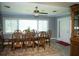 Dining room with a wooden table, chairs, a ceiling fan, a window, and an ornate hutch at 36019 Clear Lake Dr, Eustis, FL 32736