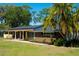 A shot of the front of the home with a brick accent wall and lush green lawn at 36019 Clear Lake Dr, Eustis, FL 32736