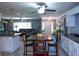 Open floorplan showcasing the kitchen with white cabinets, granite countertops, and stainless appliances at 36019 Clear Lake Dr, Eustis, FL 32736