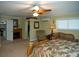 Main bedroom features a bed, a fireplace, seating, and a fan at 36019 Clear Lake Dr, Eustis, FL 32736