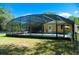 The caged pool area features a variety of seating and table options at 36019 Clear Lake Dr, Eustis, FL 32736