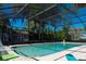 Relaxing screened-in pool with deck chairs and lush green trees around the exterior at 36019 Clear Lake Dr, Eustis, FL 32736