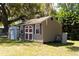 Exterior view of the shed with white and red doors and window at 36019 Clear Lake Dr, Eustis, FL 32736