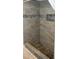 Gorgeous tiled shower featuring pebble floor, built-in seat and blue accents at 36019 Clear Lake Dr, Eustis, FL 32736