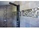 Modern shower with custom tile work, multiple shower heads, and built-in niche storage at 36019 Clear Lake Dr, Eustis, FL 32736