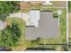 Aerial view of a single-story home featuring a well-maintained lawn, driveway, and a fire pit in the backyard at 3713 Dover St, Orlando, FL 32806