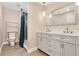 Bright bathroom featuring a double vanity with modern fixtures and a separate shower at 3713 Dover St, Orlando, FL 32806