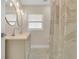 Renovated bathroom with double vanity, decorative tile floor, and a modern shower curtain at 3713 Dover St, Orlando, FL 32806