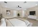 Open bedroom featuring hardwood floors, a ceiling fan, large windows, and natural light at 3713 Dover St, Orlando, FL 32806