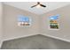 Bright bedroom featuring tile flooring, a ceiling fan, and windows overlooking the landscape at 3713 Dover St, Orlando, FL 32806