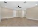 Spacious living room with tile flooring, ceiling fan, and neutral paint, flooded with natural light at 3713 Dover St, Orlando, FL 32806
