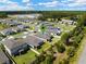 An aerial view shows the neighborhood's layout, with lush greenery and homes with well-manicured lawns at 439 Sarah Nicole Way, New Smyrna Beach, FL 32168