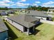 Bird's eye view showcases the home's roof and lush backyard landscaping, along with a well-planned community at 439 Sarah Nicole Way, New Smyrna Beach, FL 32168