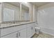 Bathroom featuring white cabinets, granite countertop and double mirrors at 439 Sarah Nicole Way, New Smyrna Beach, FL 32168