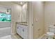 This bathroom features granite countertop, white cabinets, toilet and mirrors at 439 Sarah Nicole Way, New Smyrna Beach, FL 32168