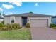 Charming single-story home featuring a brick driveway, attached garage, and well-manicured lawn at 439 Sarah Nicole Way, New Smyrna Beach, FL 32168