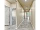 Hallway featuring tile floors and neutral paint that leads to other parts of the home at 439 Sarah Nicole Way, New Smyrna Beach, FL 32168