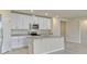 Bright kitchen with stainless steel appliances, granite counters and white cabinets at 439 Sarah Nicole Way, New Smyrna Beach, FL 32168
