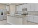 Modern kitchen with white cabinets, stainless steel appliances, and granite countertops on the island at 439 Sarah Nicole Way, New Smyrna Beach, FL 32168