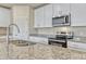 The kitchen showcases granite countertops, stainless steel appliances, and white cabinets at 439 Sarah Nicole Way, New Smyrna Beach, FL 32168