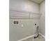 An unfinished laundry room with a shelf, a tile floor, and hookups for a washer and dryer at 439 Sarah Nicole Way, New Smyrna Beach, FL 32168