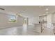Bright open-concept living space with tile flooring, seamlessly connects to the modern kitchen at 439 Sarah Nicole Way, New Smyrna Beach, FL 32168