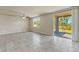 Spacious living area with tile flooring, ceiling fan, and sliding glass doors to the outdoor patio at 439 Sarah Nicole Way, New Smyrna Beach, FL 32168