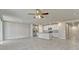 Open-concept living space showcases tile flooring, leading into the kitchen with white cabinetry at 439 Sarah Nicole Way, New Smyrna Beach, FL 32168