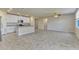 A bright and open living area featuring tile floors and seamless flow into the modern kitchen at 439 Sarah Nicole Way, New Smyrna Beach, FL 32168