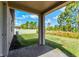 Covered patio with brick pavers overlooks the lush green backyard and surrounding trees at 439 Sarah Nicole Way, New Smyrna Beach, FL 32168