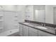 Bright bathroom featuring dual sinks, a large mirror, and a shower with tub at 4497 Yaupon Holly Way, Lakeland, FL 33811