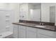 Bright bathroom featuring dual sinks, a large mirror, and a shower with tub at 4497 Yaupon Holly Way, Lakeland, FL 33811