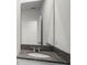 Bathroom vanity features a granite countertop with an oval sink and a framed mirror at 4497 Yaupon Holly Way, Lakeland, FL 33811