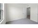 This bedroom features neutral carpet, bright white walls, and a connecting door at 4497 Yaupon Holly Way, Lakeland, FL 33811