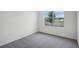 Bedroom with neutral carpeting and trim; outside view of a serene street at 4497 Yaupon Holly Way, Lakeland, FL 33811