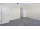 Clean bedroom with carpet flooring, bright white walls, and a white closet door at 4497 Yaupon Holly Way, Lakeland, FL 33811